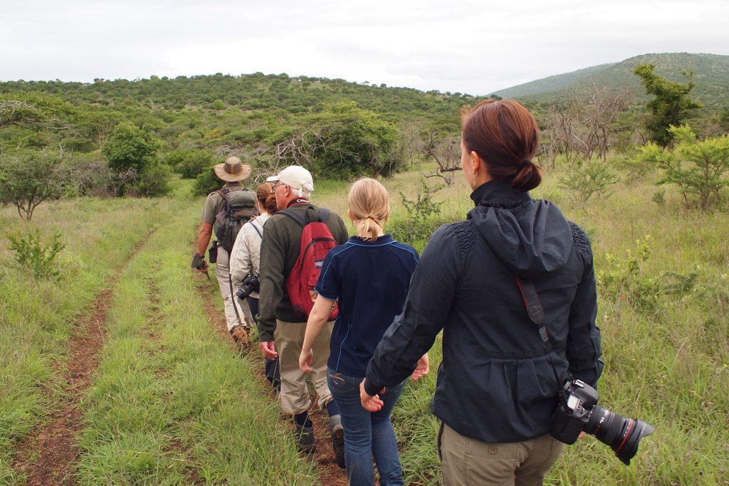 wildlife conservation volunteers with field guides and research team in Africa