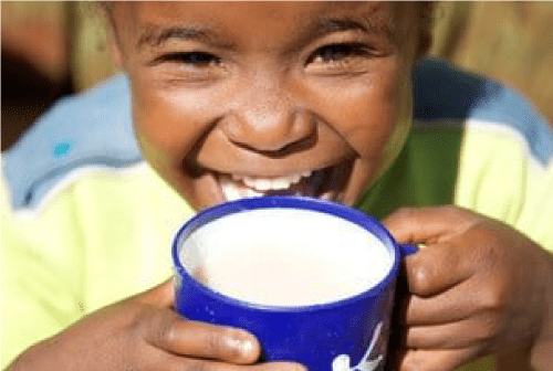 African kid holding a cup of milk