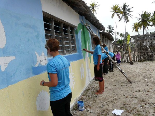 Volunteers in action painting the school