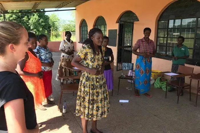 female empowerment volunteer with local Zambian ladies during a workshop