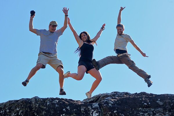 Three volunteers jumping with joy together