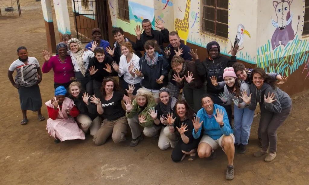 Volunteers and community members stand together for a group photo.