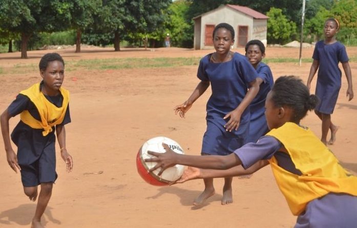 Young girls playing sports game together in Zambia