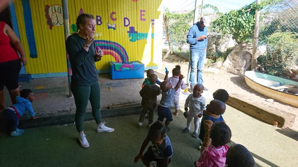 volunteer playing educational games with children in South Africa
