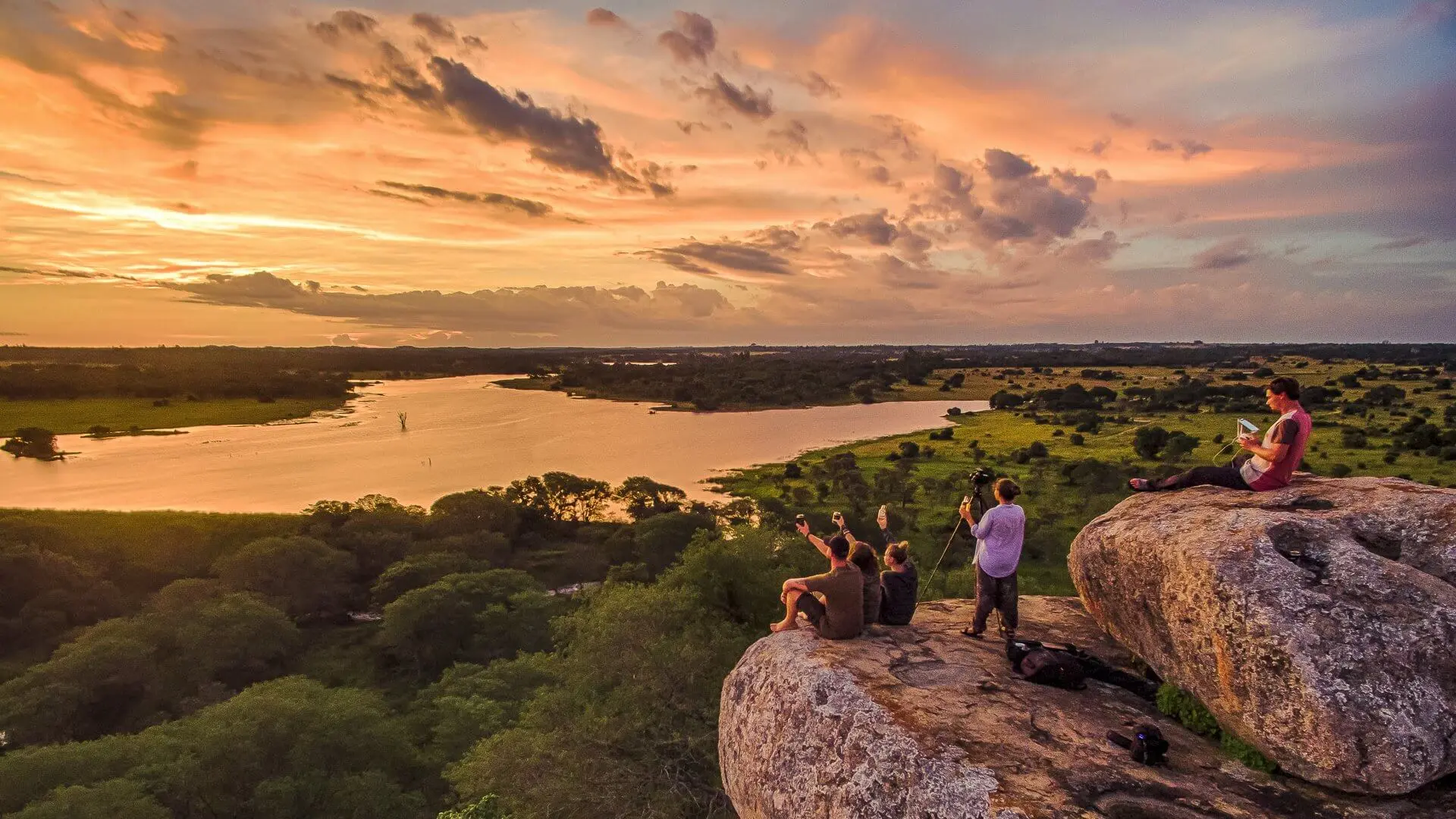 During sundown, a group of volunteers are enjoying the view of Zimbabwe.