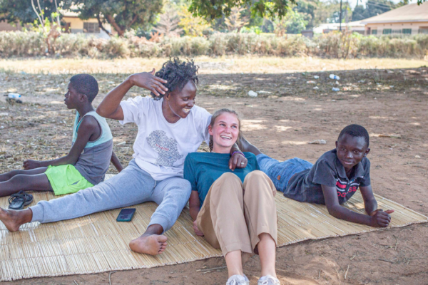 zambia gallery 2023_4 volunteers resting after a sports session with the children in zambia