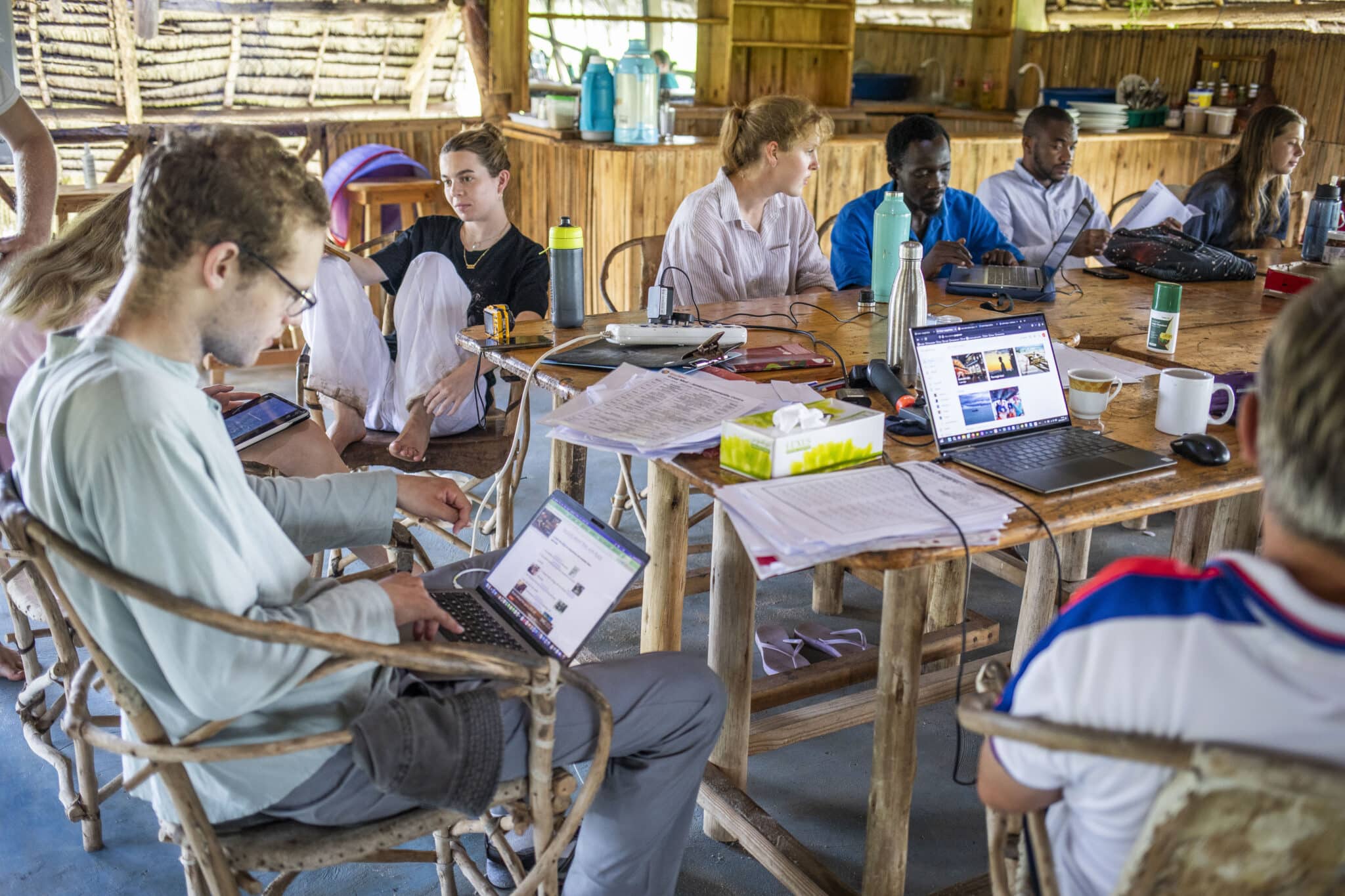 a group of volunteers working together with their laptops