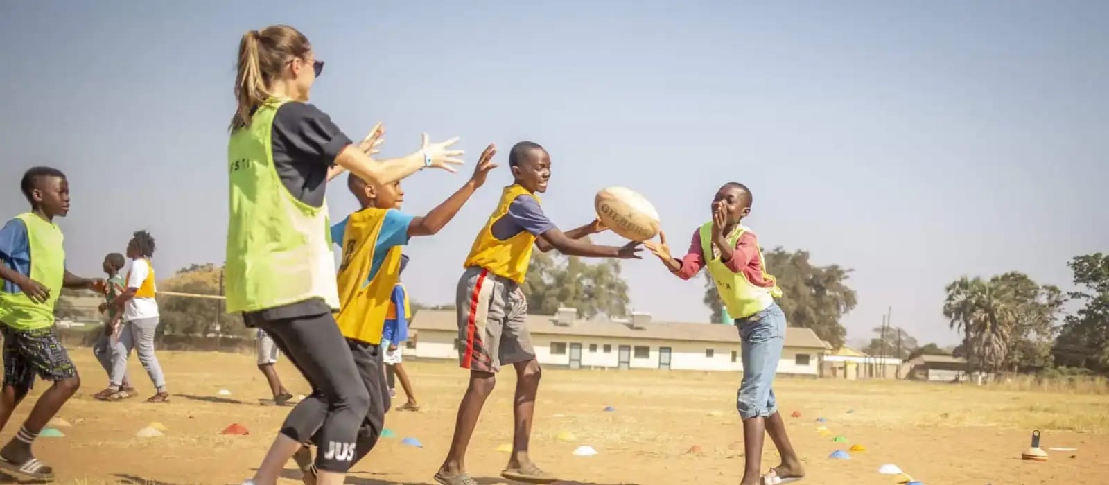 volunteer and local kids playing rugby