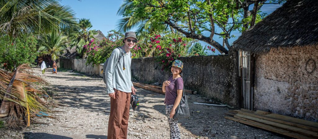 a volunteer and a local posing for a photo on a sunny day