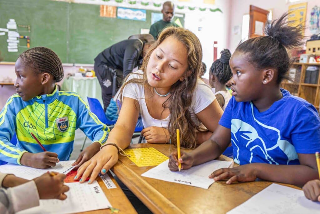 CTprojects1-30 a woman volunteer teaching young students inside a classroom