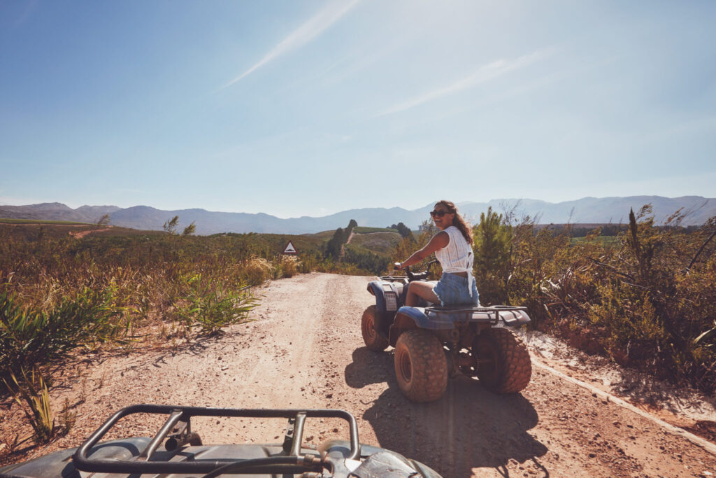 Young woman on an all terrain vehicle in nature