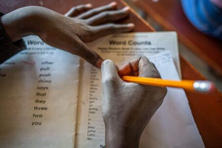 A student writing on a piece of paper