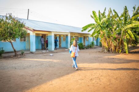A volunteer teacher walking towards the classroom
