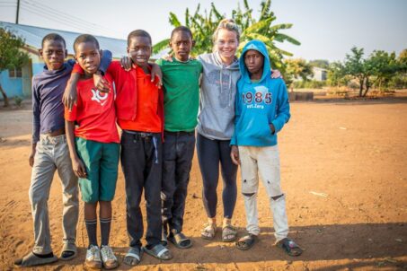 A volunteer teacher with a group of Zambian students
