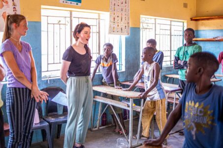 volunteer talking to kids inside the classroom