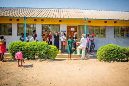 volunteers outside a classroom