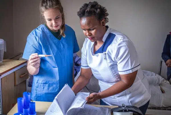 Medical volunteer assisting a patient in Cape Town hospice