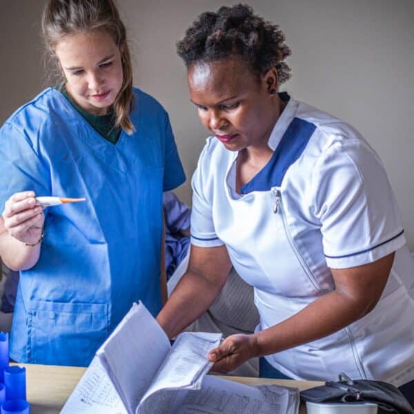Medical volunteer assisting a patient in Cape Town hospice