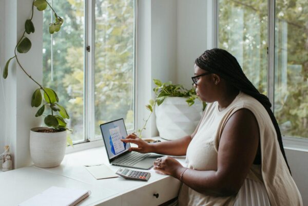 a woman sitting while using her laptop