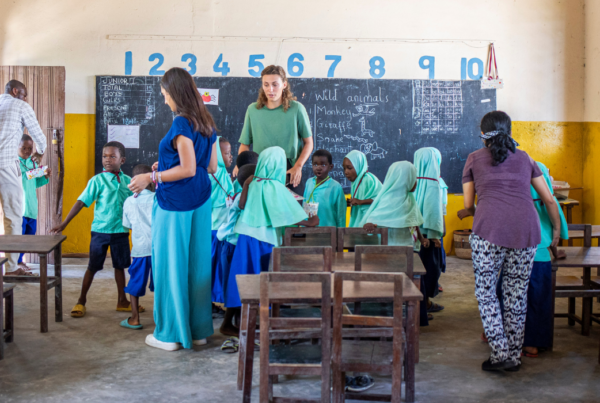 a group of volunteers with young children in a classroom