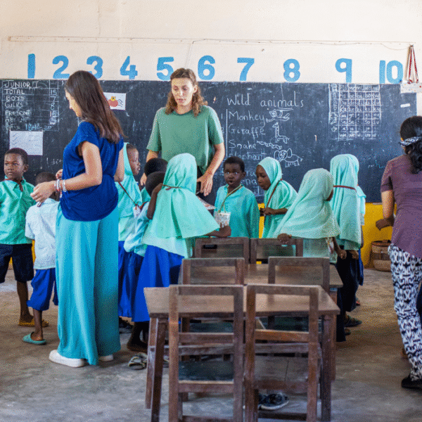 a group of volunteers with young children in a classroom