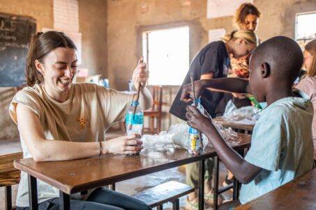A volunteer teaching local students