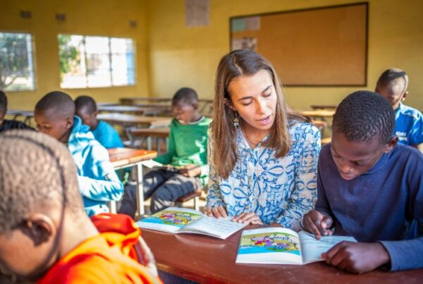 A volunteer teacher instructing a student