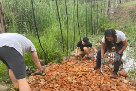 Three people working on the ground
