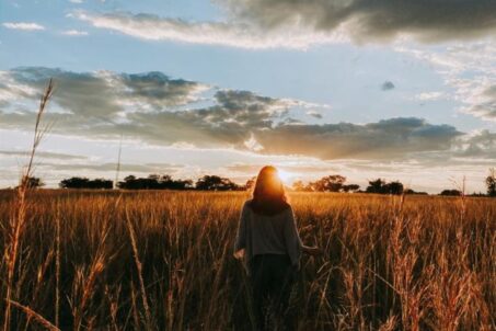 A woman standing in a wide field